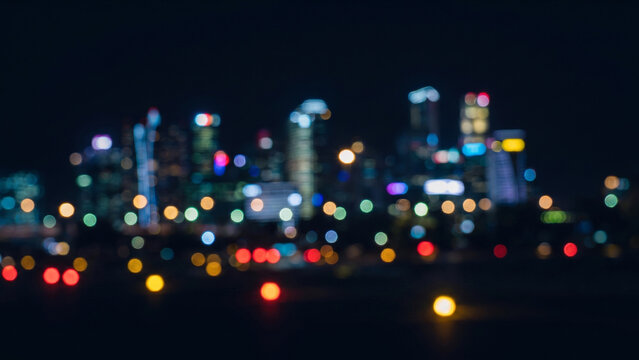 漆黒の空間で整列を始める赤と黄の玉ボケと都市夜景の初期状態抽象背景