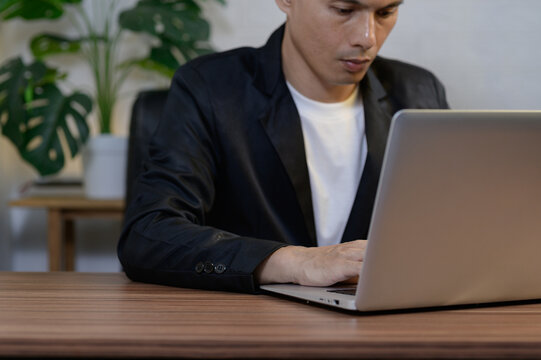 Young Professional Working on Laptop in Modern Office Environment