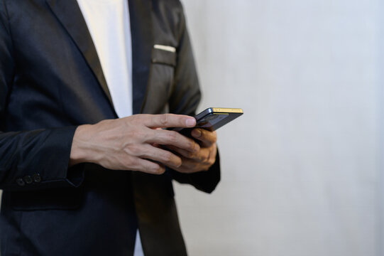Person in Suit Using Smartphone with Minimalistic Background