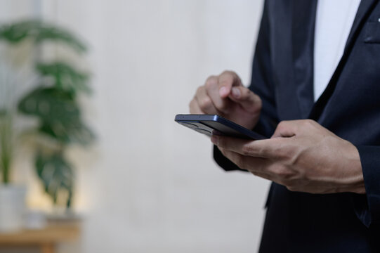 Business Professional Using Smartphone in a Modern Office Setting