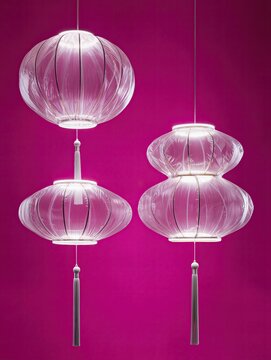 A group of three traditional Chinese lanterns recreated entirely from transparent inflated plastic, different rounded shapes and hanging tassels, soft wrinkles and inflated contours