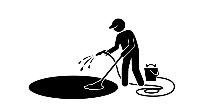 Person cleaning oil spill with pressure washer