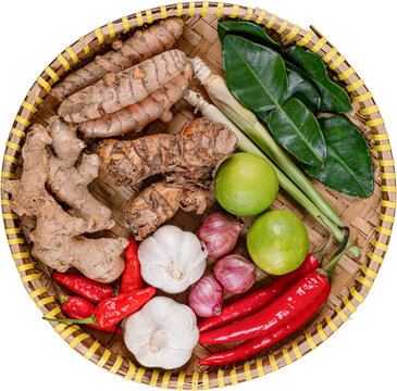 Top view raw spices ingredients turmeric ginger garlic chili woven bamboo tray isolated on transparent background