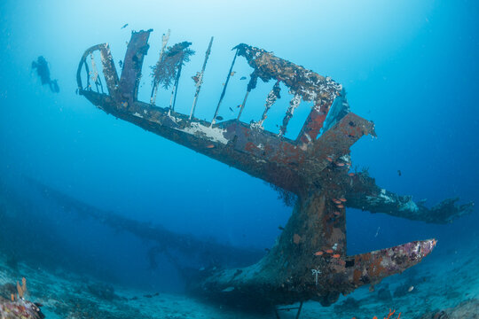 Sunken WWII PBY Catalina Seaplane Tail Section with Diver Silhouette in Biak Papua Wide Angle Underwater Photography