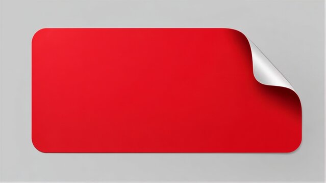 Red rectangular sticker peeling at corner on gray surface