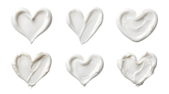 Set of white cosmetic cream smears in the shape of hearts isolated on transparent background