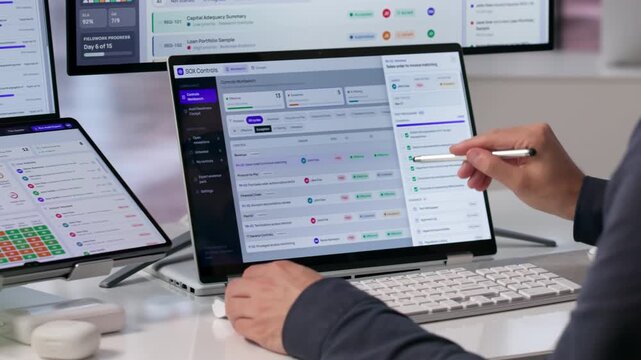 Auditor Reviews Compliance Dashboard On Touchscreen Laptop