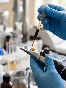 Placing Juice Droplet on Handheld Optical Refractometer for Brix Analysis