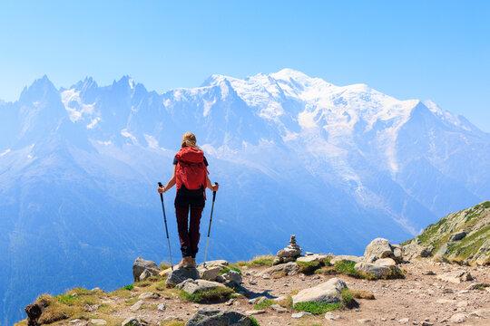 Woman hiker admiring panoramic view of mont blanc massif from mountain summit- Adventure, sport, inspiration concept