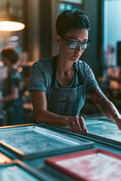 Focused artisan works with screen printing tools