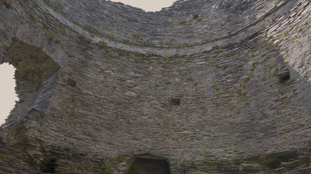 Detailed view of the inside of the Dolbadarn castle tower, Camera moving upwards showing the inside of the details of the stone work ruins of the tower. 4k 30fps.