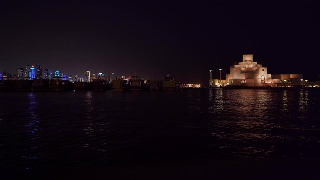 Traditional wooden dhow boat and modern museum skyline in Doha