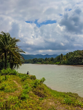 Man Fishing at River Estuary beside Taman Beach Pacitan