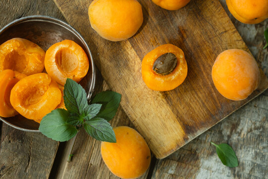 Fresh apricots on wooden table. Summer seasonal fruits.