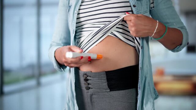 Person Quickly Uses Auto Injector On Thigh