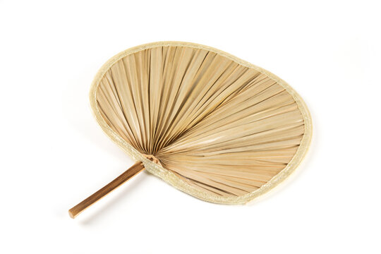 traditional handcrafted palm leaf fan isolated on white background