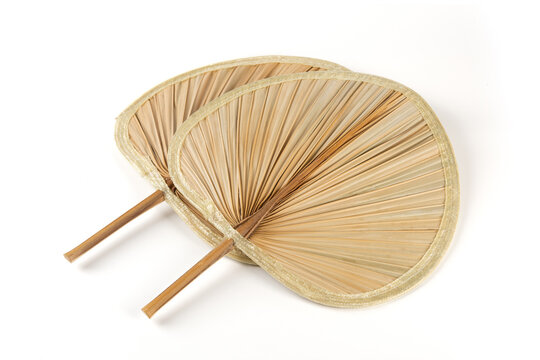 traditional handcrafted palm leaf fan isolated on white background
