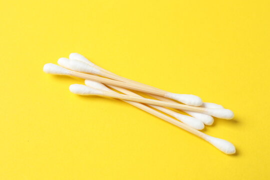 Cotton swabs on a colored background (top view)
