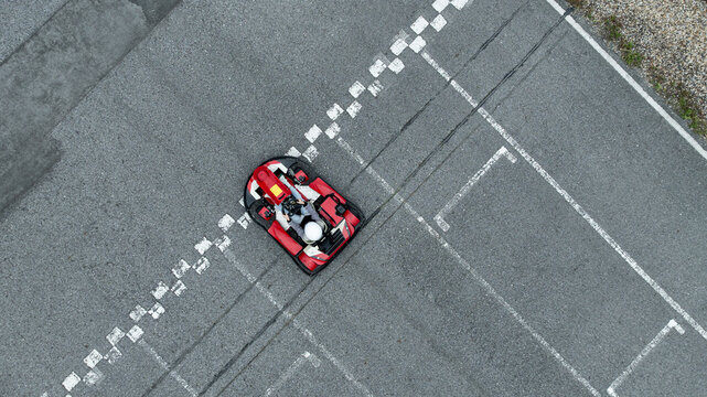 Aerial view Go kart racer cross the finish line, Go kart at circuit start and finish line, Top view race go kart track.