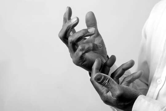 praying to god with hands showing his religious faith with God Caribbean man praying with background with people stock photo stock image	