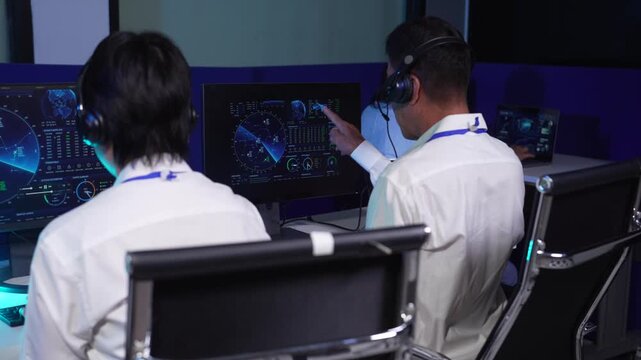 Air traffic controller monitors flight radar screens in a modern dark command center, aviation technology, flight safety, surveillance and precision.