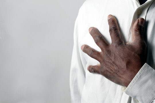 praying to god with hands showing his religious faith with God Caribbean man praying with background with people stock photo stock image	