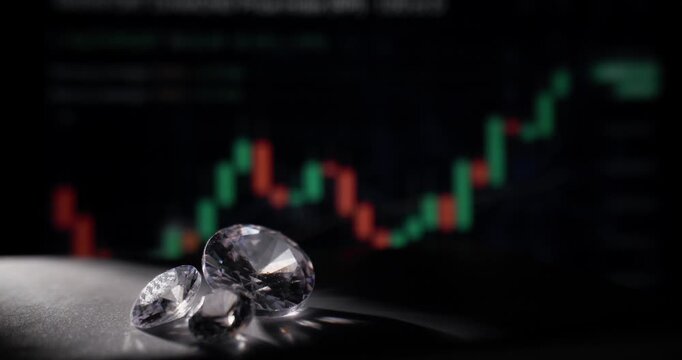 Diamonds reflecting light on tabletop with blurred market candlestick chart background, probe lens.