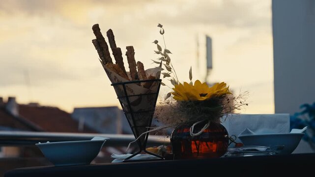 Rooftop Table Setup with Sunflower Decoration and Breadsticks Catering at Golden Hour Sunset
