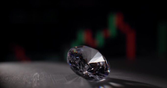 Diamond gemstone on tabletop with blurred financial market candlestick chart in background, probe lens.