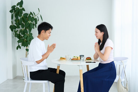 Young Japanese Man and Woman Enjoying Light Meal Together at Table