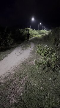 Man Running on Path at Night