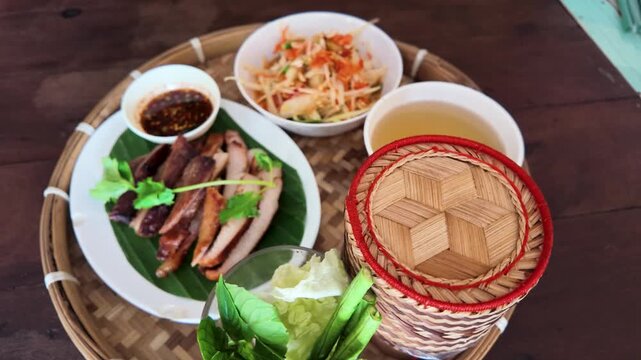Traditional Thai Meal with Grilled Pork and Papaya Salad