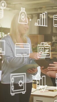 Animation of icons and data processing over diverse business people working in office