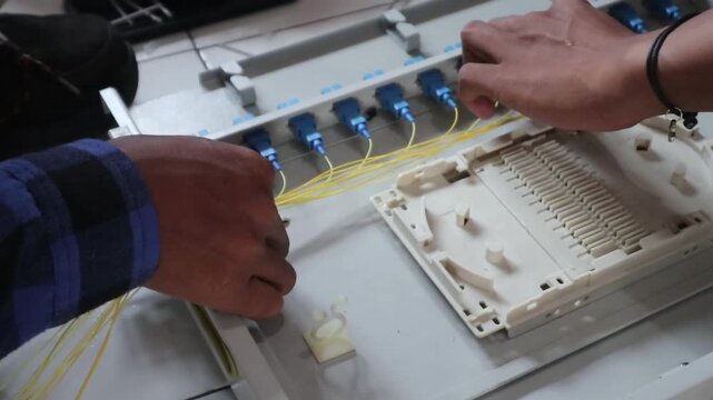 Technicians install fiber optic cables