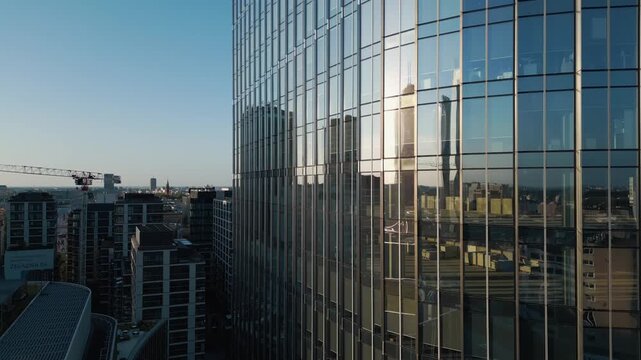 exterior of modern office building from glass and steel, city reflection in mirrors, contemporary architecture of financial district