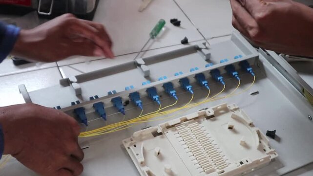 Technicians install fiber optic cables