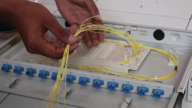 Technicians install fiber optic cables