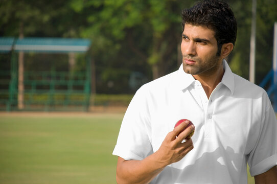 Player holding a cricket ball 