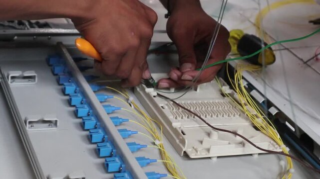 Technicians install fiber optic cables