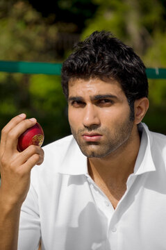 Bowler checking the cricket ball 