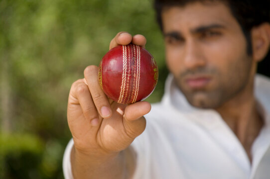 Bowler checks the cricket ball 