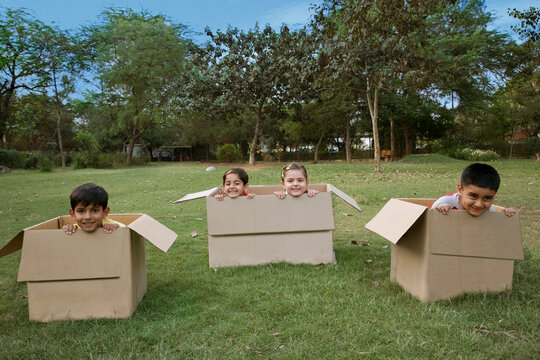 Children sitting in boxes 