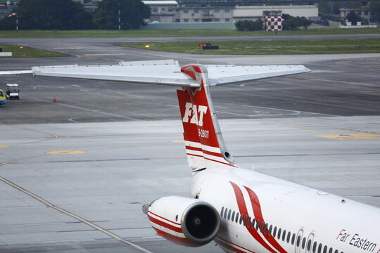 A close view shows the tail fin and engine of an airplane.