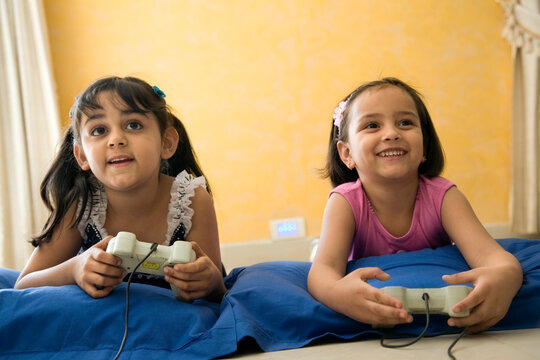 Little girls playing video game 