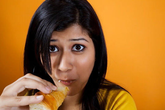 Woman eating a patty 