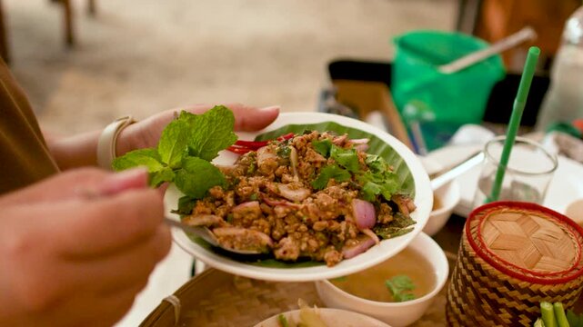 Person Eating Traditional Thai Larb Moo Minced Pork Salad