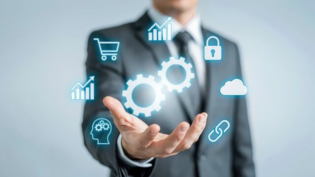 Businessman holding glowing digital gears and business icon symbols for technology integration strategy
