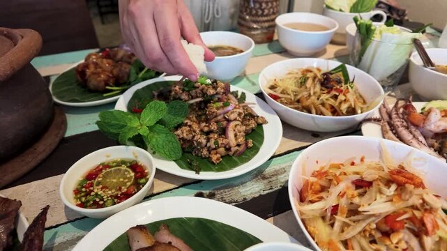 Person Eating Thai Street Food With Sticky Rice in Bangkok