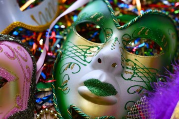 mardi gras carnival masks between confetti © Adriana