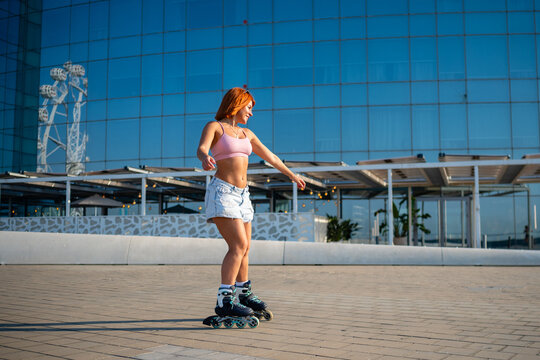 Young woman roller skating in city enjoying freedom